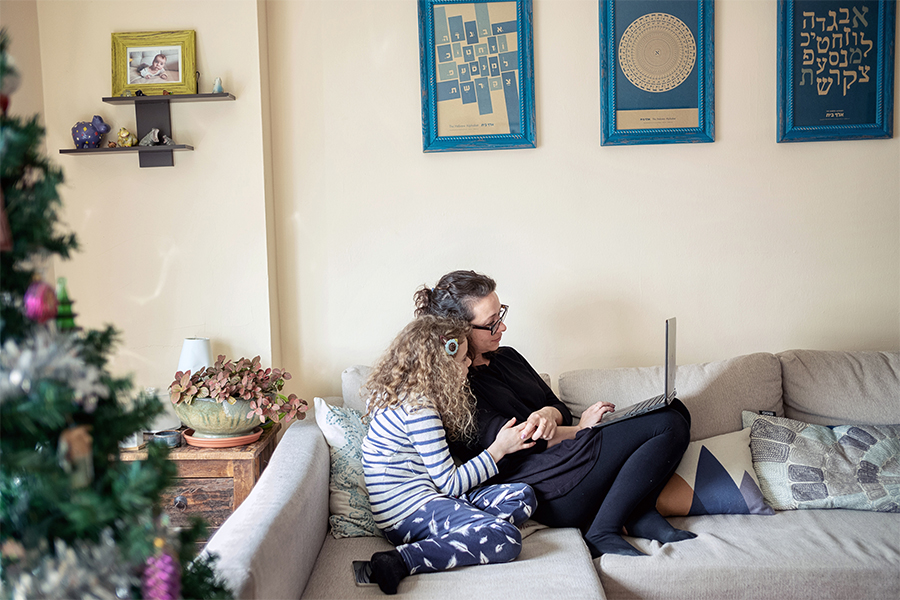 Jane Tuv, with her daughter, Lila, chatting by video with her aunt in Kyiv, Ukraine at their apartment in Queens. Tuv is having so many panic attacks about her aunt, who is refusing to leave, that she has turned to medication. (Misha Friedman/The New York Times)