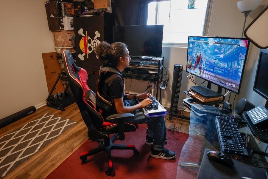 Chris Robinson plays a video game in his apartment on March 26, 2022, in Justice, Illinois.
Image: Kamil Krzaczynski / AFP