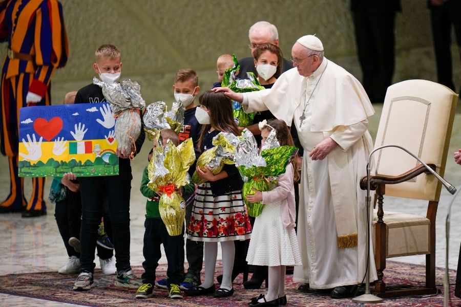 Pope Francis greets children refugees from Ukraine, during his weekly general audience in the Paul VI Hall, at the Vatican, Wednesday, April 6, 2022. Ukrainian script on the drawing reads 