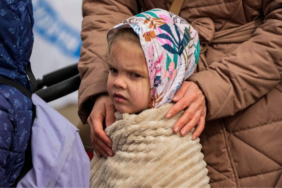 Pope Francis greets children refugees from Ukraine, during his weekly general audience in the Paul VI Hall, at the Vatican, Wednesday, April 6, 2022. Ukrainian script on the drawing reads 