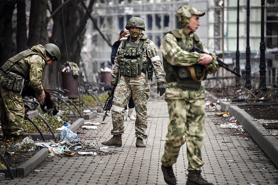 Russian soldiers walks along a street in Mariupol on April 12, 2022, as Russian troops intensify a campaign to take the strategic port city, part of an anticipated massive onslaught across eastern Ukraine, while Russia's President makes a defiant case for the war on Russia's neighbour. (Credit: Alexander NEMENOV / AFP)