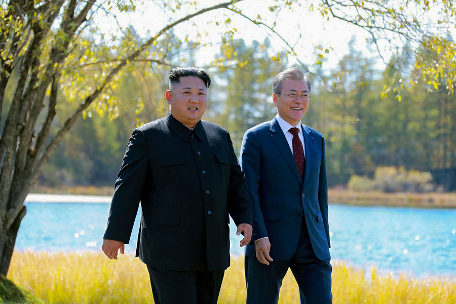 This picture taken on September 20, 2018 and released by Korean Central News Agency (KCNA) via KNS shows North Korea's leader Kim Jong Un (L) and South Korean President Moon Jae-in (R) walking together during a visit to Samjiyon guesthouse near Mount Paektu in Samjiyon. (Photo by KCNA VIA KNS / various sources / AFP)