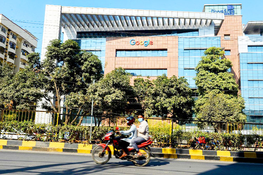 A motorist rides along a road in front of the Google India office building in Hyderabad on January 28, 2022. The Indian government on Wednesday unexpectedly withdrew a proposed bill on data protection that a panel of lawmakers had been laboring over for more than two years, saying it was working on a new law. Image: Noah Seelam / AFP