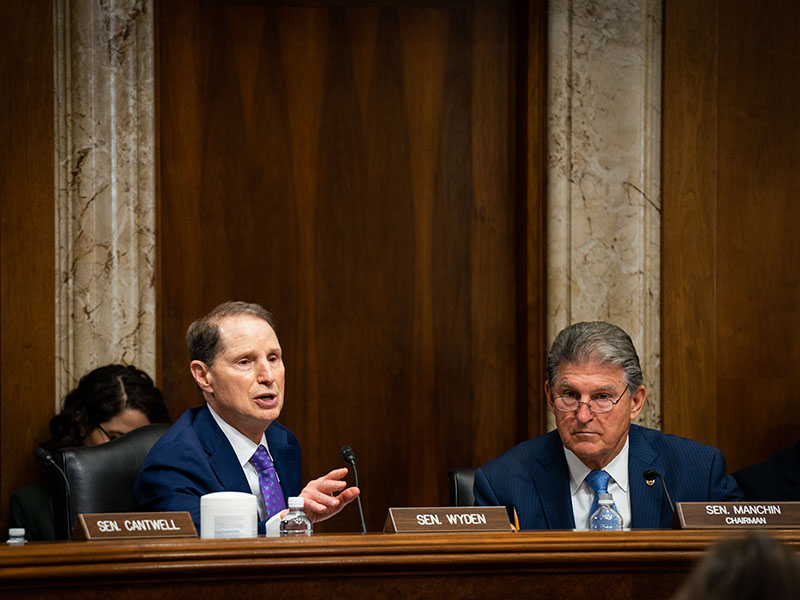 Sens. Ron Wyden (D-Ore.), left, and Joe Manchin (D-W.Va.) at a hearing about U.S. infrastructure on Capitol Hill in Washington, June 24, 2021. The Senate’s historic climate legislation avoided the political pitfalls of past legislative attempts by offering only incentives to cut climate pollution, not taxes. (Sarahbeth Maney/The New York Times)