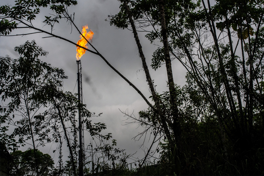 A gas flame burned at an oil well in Putumayo, Colombia on Feb. 6, 2022. One of the world’s largest sustainable development agencies has worked with energy companies to quash opposition and keep oil flowing, even in sensitive areas. (Federico Rios/The New York Times