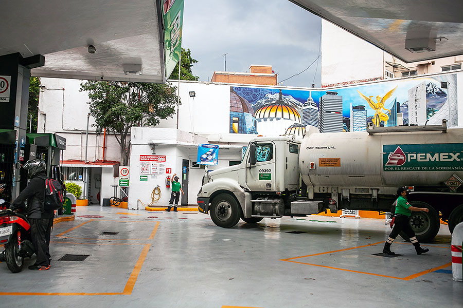 A gasoline tanker truck unloads at a service station in Mexico City on June 27, 2022. Mexico is using money it makes from the crude oil it produces to subsidize gas prices. (Celia Talbot Tobin/The New York Times)