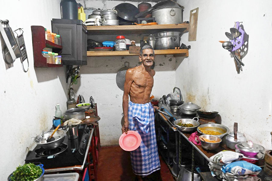 This photo taken on July 17, 2022 shows Milton Perera looking on in his kitchen in the Slave Island neighbourhood of Colombo. In the face of a months-long economic crisis that has seen rampant inflation and protests that last week brought down the president, Sri Lankans are buying less, eating less and working less. Image: Arun SANKAR / AFP

