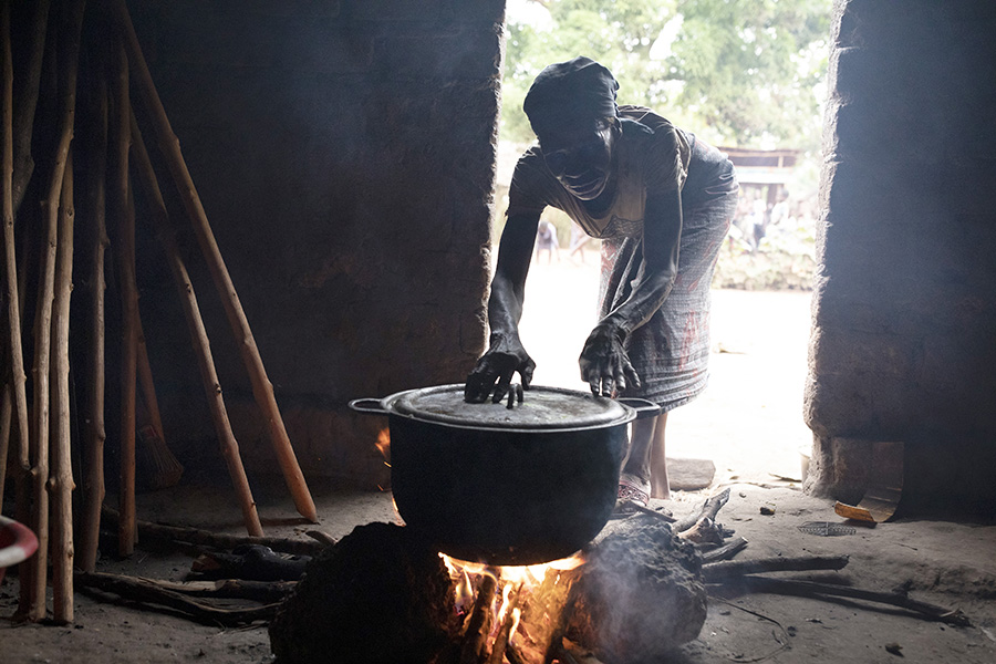 A kiln for making charcoal, widely used for cooking, along a Congo River tributary in Mbandaka, Democratic Republic of Congo, on March 16, 2022. In the Congo River Basin, a rainforest that rivals the Amazon in importance, people who collect bundles of wood to make charcoal play a surprisingly large role in deforestation. (Ashley Gilbertson/The New York Times)