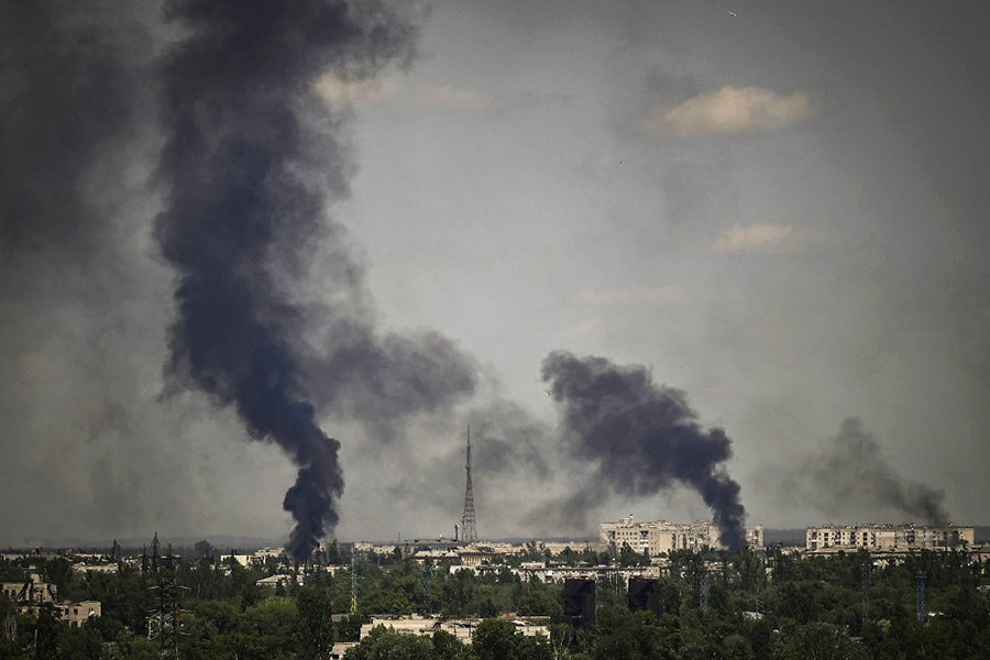 Smoke rises in the city of Severodonetsk during heavy fightings between Ukrainian and Russian troops at eastern Ukrainian region of Donbas on May 30, 2022, on the 96th day of the Russian invasion of Ukraine. EU leaders will try to overcome Hungary's rejection of a Russian oil embargo on May 30, 2022 as part of a further tightening of sanctions against Moscow, whose forces are advancing in eastern Ukraine, with fighting in the heart of the key city of Severodonetsk. (Credits: ARIS MESSINIS / AFP)