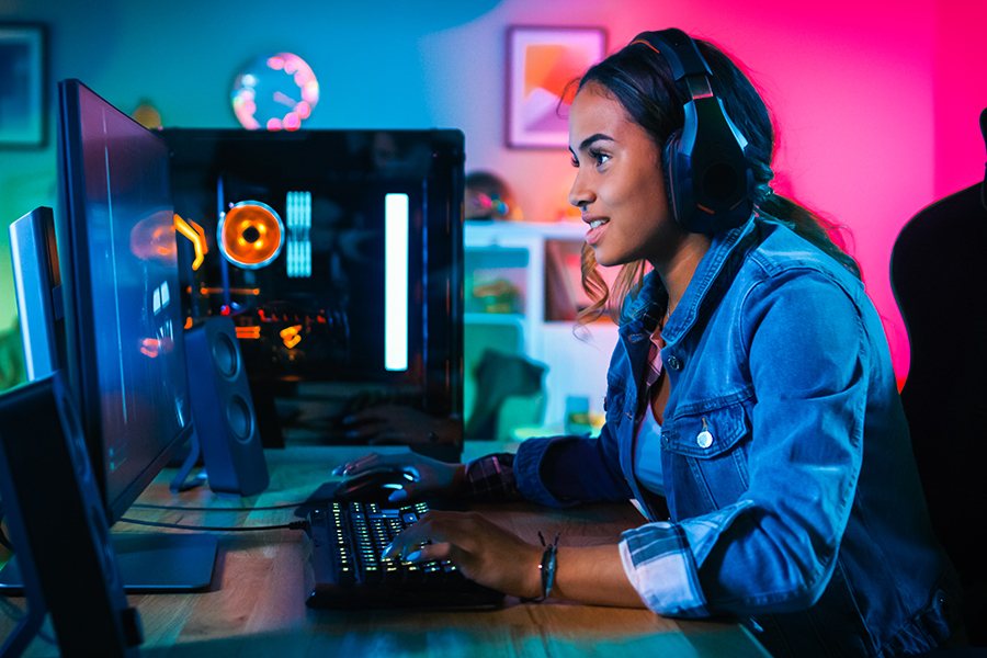 Female gamer is playing on her PC.  According to the report launched by EY in 2022, the number of women gamers grew by 18 percent in 2021. And it is expected to grow by 20 percent by the end of 2022.