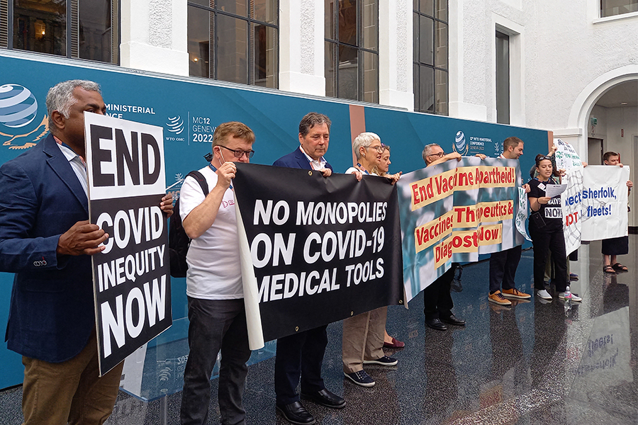 Non-governmental organisation members shout slogans and hold banners as they stage a protest in the World Trade Organization headquarters' central atrium during the second day of a WTO Ministerial Conference in Geneva on June 13, 2022. (Image: Robin MILLARD / AFP)

