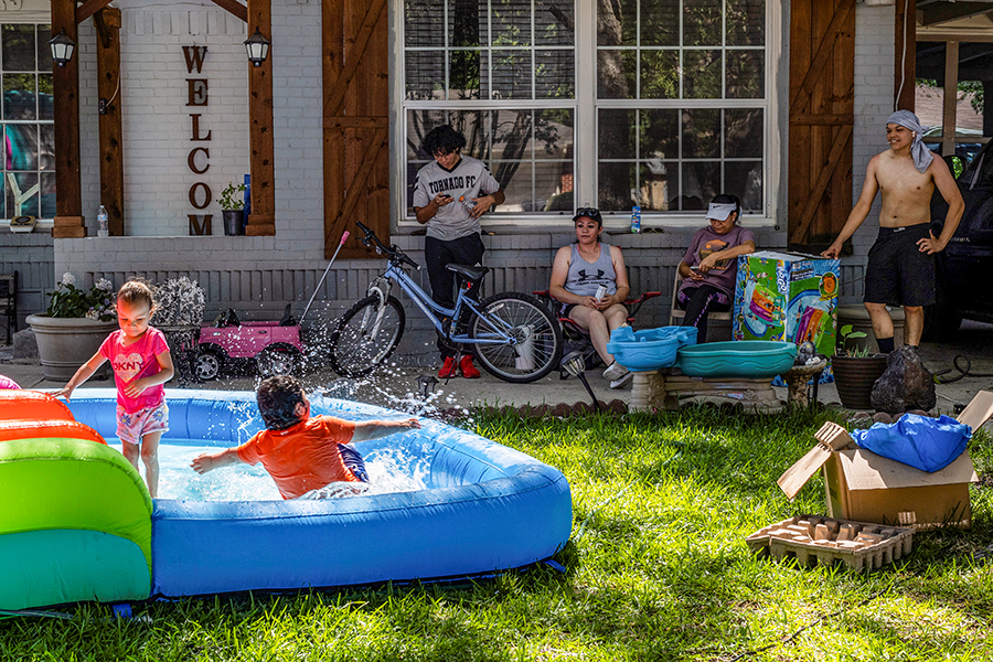 Neighbors Samuel Hernandez, Maria Hernandez, Luisa Ortega and Issac Montelongo sit outside as they watch the kids play in water during a heatwave with expected temperatures of 102 F (39 C) in Dallas, Texas, U.S. June 12, 2022. Though the heat wave caused electricity use in Texas to reach an all time high, the power grid remained largely stable without major issues.
Image: Shelby Tauber / Reuters