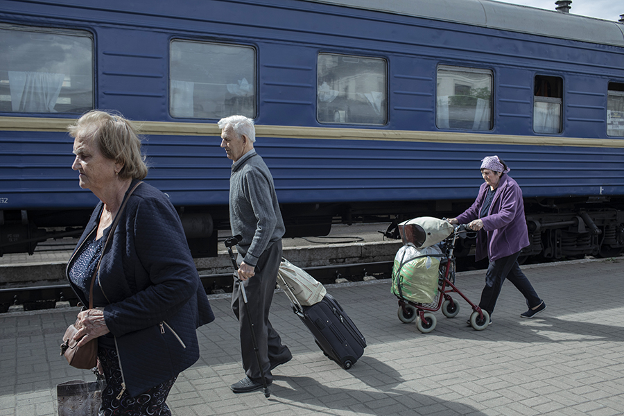 Valentyna Yaburova, left, and her husband Yegor Yaburov, walk down the platform at Lviv’s main train station after arriving aboard an evacuation train from Pokrovsk in eastern Ukraine, June 15, 2022. The family originally evacuated from Pokrovsk, on the Donetsk regioin of eastern Ukraine. (Emile Ducke/The New York Times)