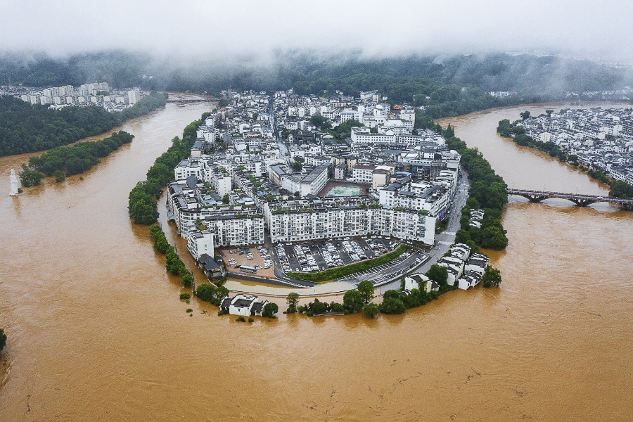 This aerial photo taken on June 20, 2022 shows flooded streets and buildings following heavy rains in Wuyuan, in China's central Jiangxi province. Image: CNS / AFP

