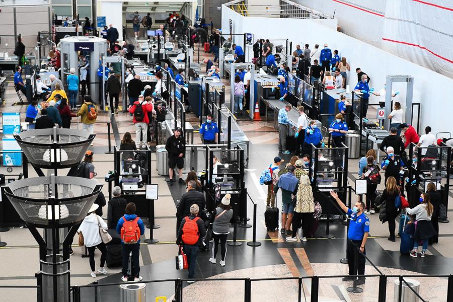 Airline passengers wait at a checkpoint to clear security before boarding to flights in the airport terminal in Denver, Colorado on April 19, 2022. Image: Patrick T. Fallon / AFP

