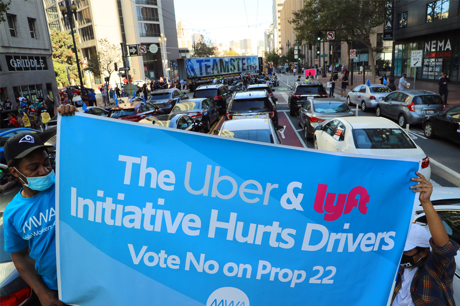 A protest on Oct. 15, 2020, outside Uber’s headquarters in San Francisco, urging voters to reject Proposition 22, which would have locked in the independent contractor status of drivers. A group of drivers claimed on Tuesday, June 21, 2022, that Uber and Lyft are engaging in anticompetitive practices by setting the prices customers pay and limiting drivers’ ability to choose which rides they accept without penalty. (Jim Wilson/The New York Times)