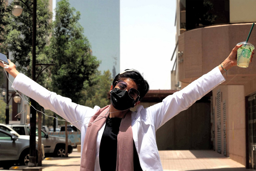 Safi, a 26-year-old Saudi physician, poses for a photo with her short hair near the Kingdom Centre skyscraper in the centre of Saudi Arabia's capital Riyadh on June 19, 2022.