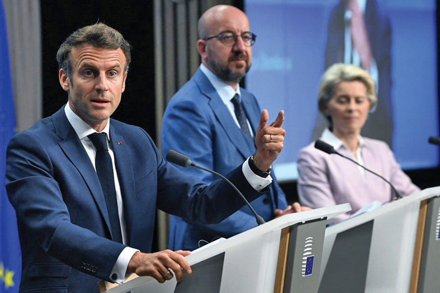 France's President Emmanuel Macron (L), President of the European Council Charles Michel (C) and President of the European Commission Ursula von der Leyen (R) attend a press conference during an European Council in Brussels on June 23, 2022. - European Union leaders on June 23, 2022 agreed to grant 