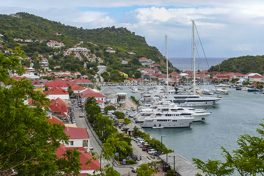 Megayachts in the harbor at Gustavia, the capital of the Caribbean island of St. Barts, Feb. 12, 2022. A legal feud over a proposed luxury hotel pits development against the fragile nature on this tropical Arcadia for the ultrarich. (Jean Vallette/The New York Times)