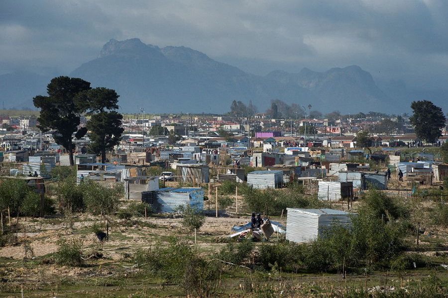 A general view shows the newly established informal settlement, as workers, begin demolishing uninhabited shacks in Bloekombos, Kraaifontein, in Cape Town.This land, due to be developed for civic amenities, for nearby communities, was illegally occupied by people, who marked out plots, and built informal dwellings. (Credit: RODGER BOSCH / AFP)