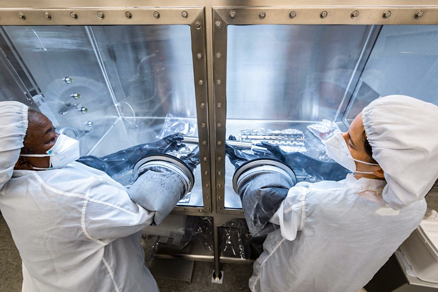 This handout photo released by NASA shows NASA researchers opening an Apollo 17 Moon rock sample at NASAís Johnson Space Center in Houston on February 15, 2022. - The Apollo missions to the Moon brought back to Earth a total of 2,196 lunar rock samples. But NASA has only just begun to open one of the last, collected 50 years ago. (Credit: Robert MARKOWITZ / NASA / AFP)

