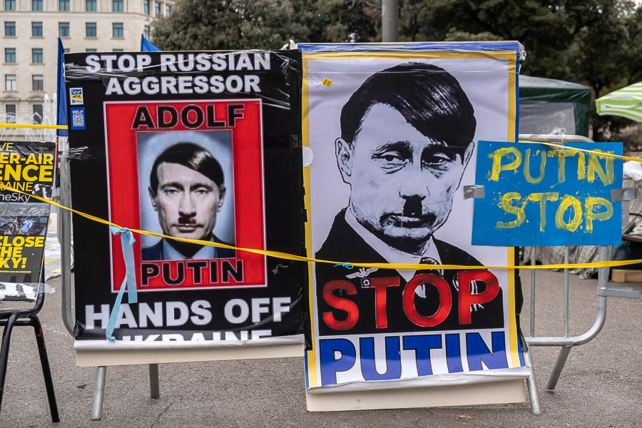 Posters depicting Russian President Vladimir Putin as Adolf Hitler are seen in Plaza Catalunya. There has been widespread opposition to Russia's invasion of Ukraine, with protests taking place in many European cities. Image: Paco Freire/SOPA Images/LightRocket via Getty Images