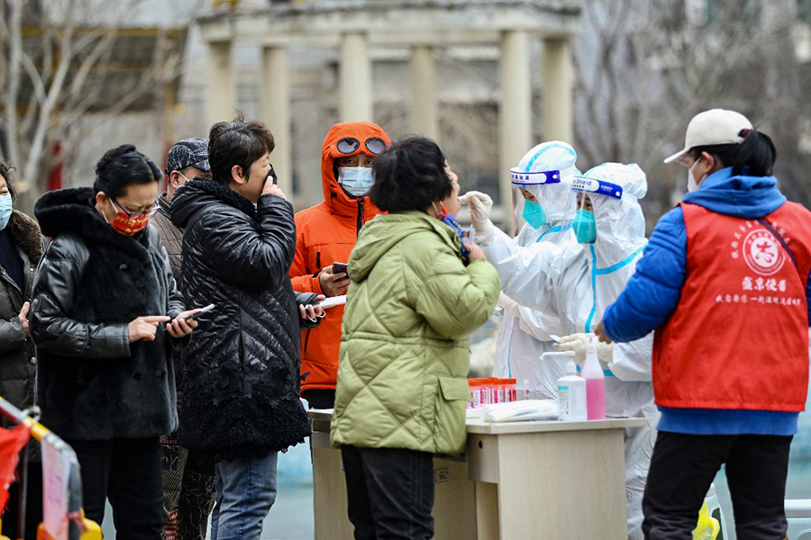 This photo taken on March 14, 2022 shows a resident underging a nucleic acid test for the Covid-19 coronavirus in Shenyang, in China's northeastern Liaoning province. (Credit: AFP)