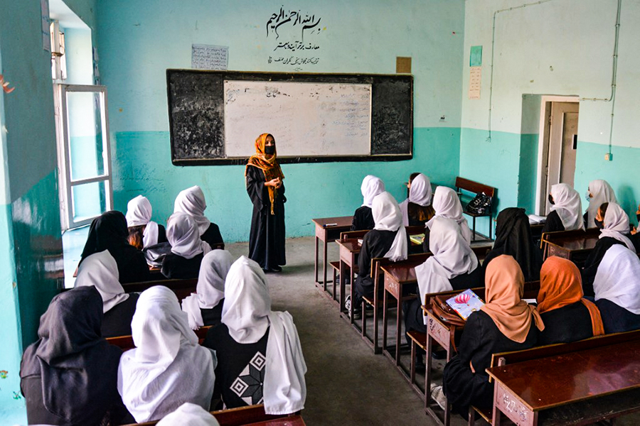 Girls attend a class after their school reopened in Kabul on March 23, 2022. - The reopening of secondary schools for girls across Afghanistan on March 23 prompted joy and apprehension among the tens of thousands of students deprived of an education since the Taliban's return to power. (Credit: Ahmad SAHEL ARMAN / AFP)
