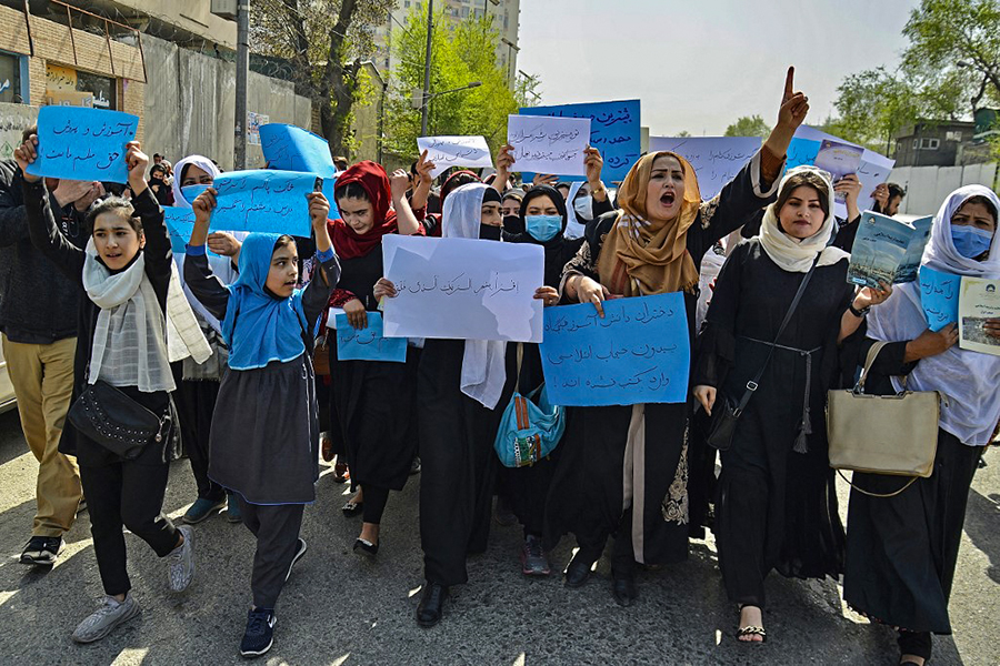 Afghan women and girls take part in a protest in front of the Ministry of Education in Kabul on March 26, 2022, demanding that high schools be reopened for girls. Image: Ahmad SAHEL ARMAN / AFP