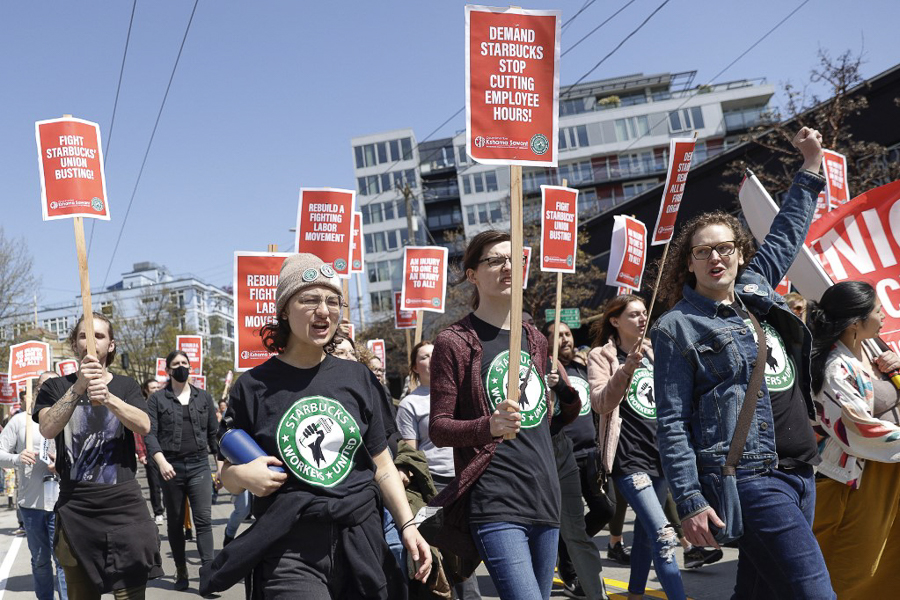 People march in the middle of East Pine Street during the 