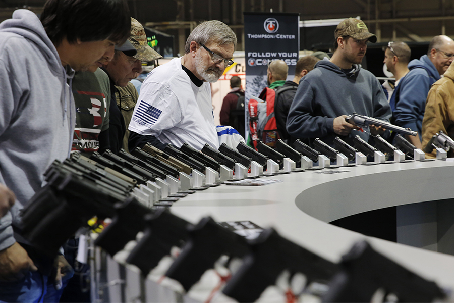 Visitors view gun displays at a National Rifle Association outdoor sports trade show on February 10, 2017 in Harrisburg, Pennsylvania. The Great American Outdoor Show, a nine day event celebrating hunting, fishing and outdoor traditions, features over 1,000 exhibitors ranging from shooting manufacturers to outfitters to fishing boats and RVs, and archery to art. Image: DOMINICK REUTER/AFP via Getty Images