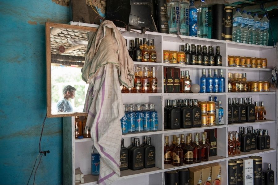 A shop selling bottles of Nepali alcohol, with labels that often copy designs from well know international brands, near Maruwai, Nepal, April 15, 2022. Since the Indian state of Bihar banned alcohol in 2016, a small industry of bars and restaurants has sprung up just across the border in Nepal, catering to Indians of all classes seeking to quench their thirst. Image: Saumya Khandelwal/The New York Times