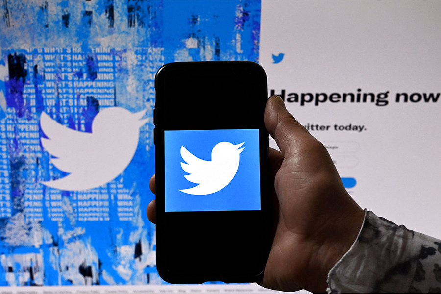 A phone screen displays the Twitter logo on a Twitter page background, in Washington, DC.