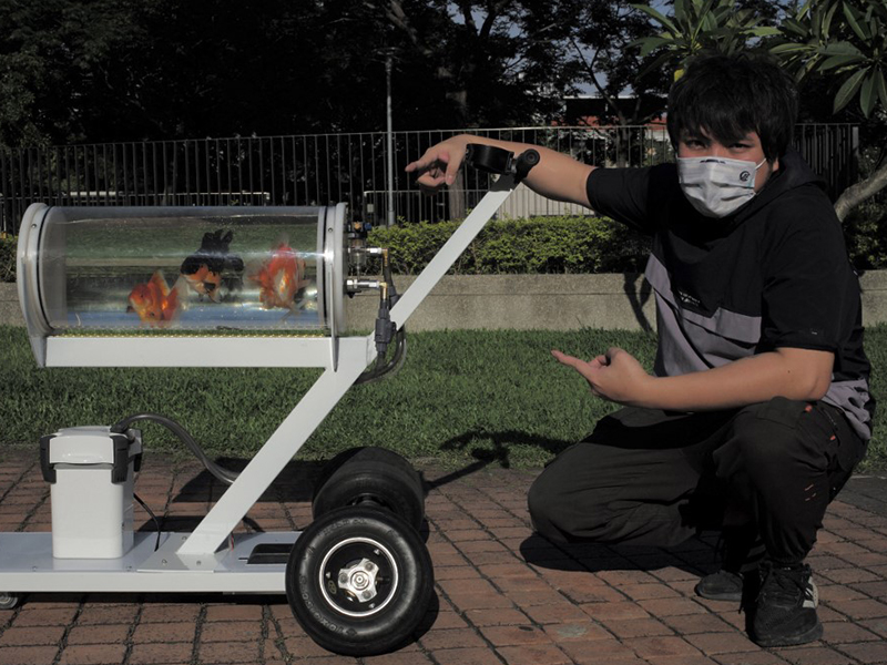 Jerry Huang, maker and fish enthusiast, poses with his fish tank trolley for photographs at a park in Taichung, central Taiwan, on May 19, 2022.
Image: Sam Yeh / AFP