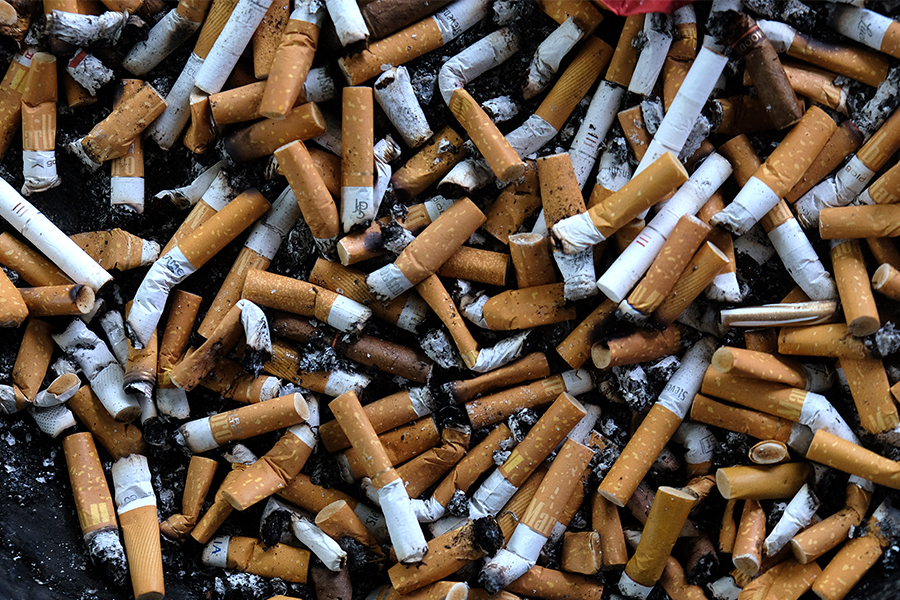 An ashtray filled with cigarettes butts.