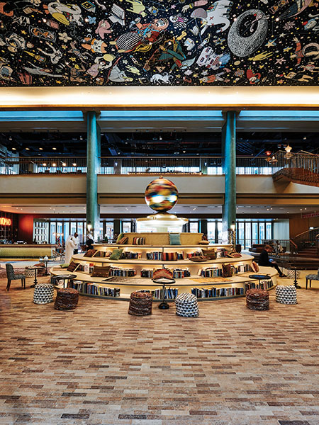 The lobby of LGBTQ-friendly design hotel 25hours features a lobby with a fountain and co-working space