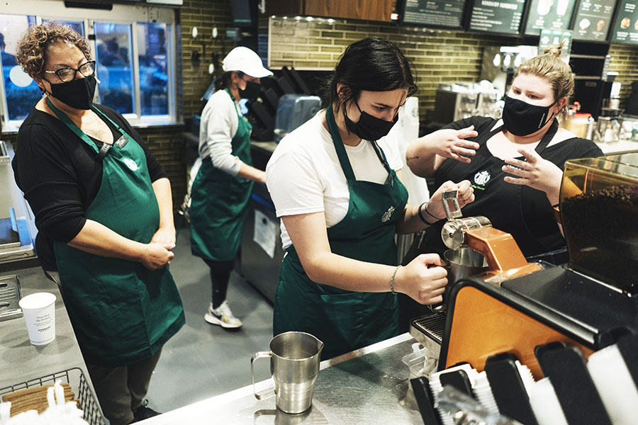 Starbucks baristas in training at a location in Cheektowaga, N.Y., Oct. 13, 2021. The coffee giant intends to increase automation at its stores and open thousands of additional locations in China over the next three years. (Libby March/The New York Times)