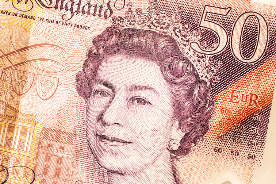 British currency is displayed for a photograph in London on Thursday, Sept. 15, 2022. Queen Elizabeth II’s image is ubiquitous. But before long, the visage of King Charles III will replace his mother’s in official and unofficial capacities. (Alexander Coggin/The New York Times)