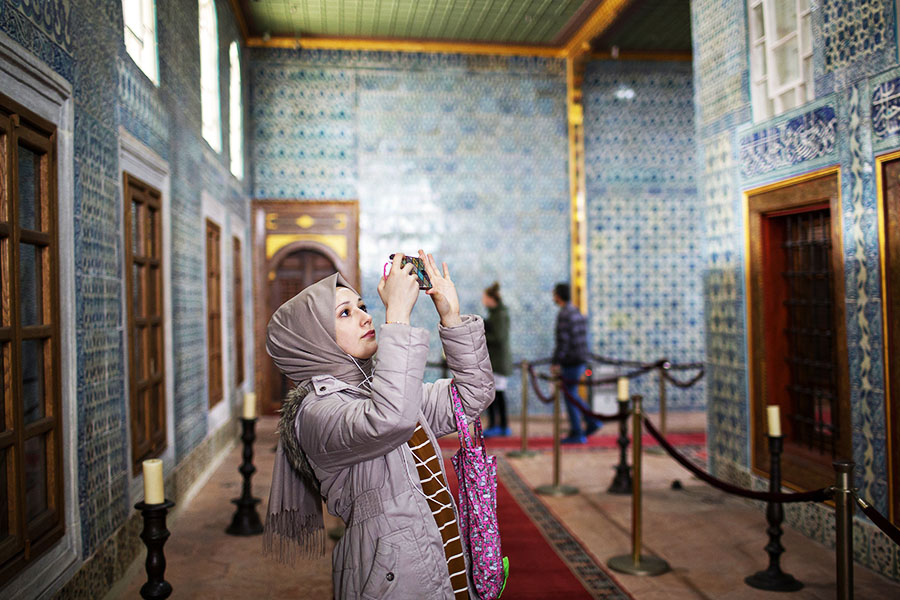 A woman takes pictures in Hünkar Kasri in Istanbul in November 2019. All the walls at Hünkar Kasri are covered in rare and exquisite Iznik tiles from the 17th century, some specially created for this building. Image: Danielle Villasana/The New York Times