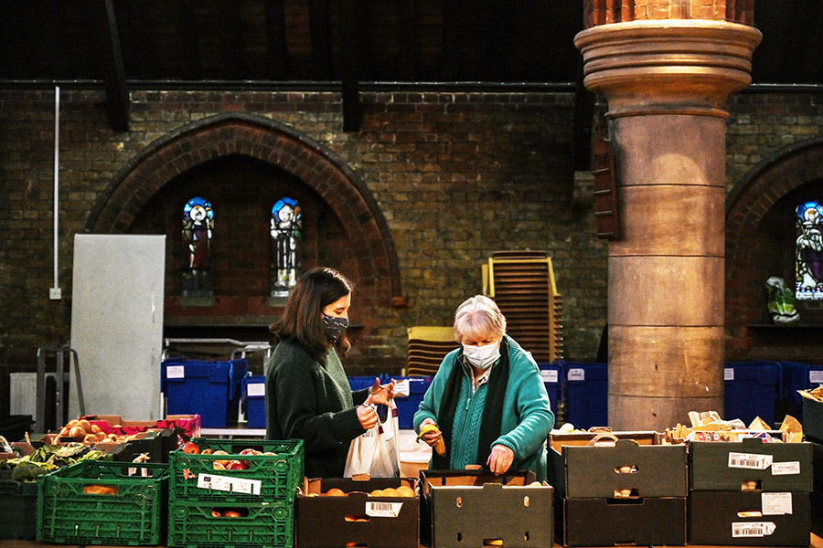 Volunteers at a food bank in London, Jan. 27, 2022. The Bank of England on Thursday, Sept. 21, 2022, raised interest rates by half a point to 2.25 percent, even as it said that the United Kingdom might already be in a recession. (Mary Turner/The New York Times)