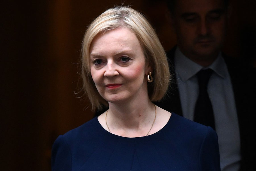 Britain's Prime Minister Liz Truss walks out of Number 10 Downing Street on her way to the House of Commons for the government's anti-inflation budget plan in London. Image: Daniel LEAL / AFP

