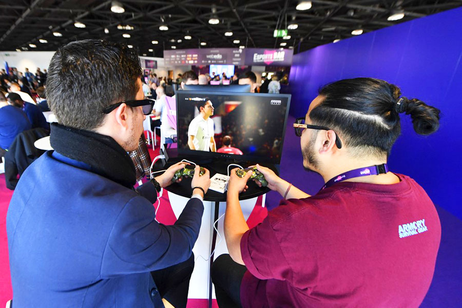 This file photograph shows visitors playing on EA Vancouver video game developer's football simulation video game FIFA 19 at the eSports Bar trade fair in Cannes, southern France on February 13, 2019. The 2023 edition of Fifa, the leader of soccer simulation video games, will be out on September 30, 2022, as it is developed each year by the US game maker Electronic Arts since 1993. Image: YANN COATSALIOU / AFP

