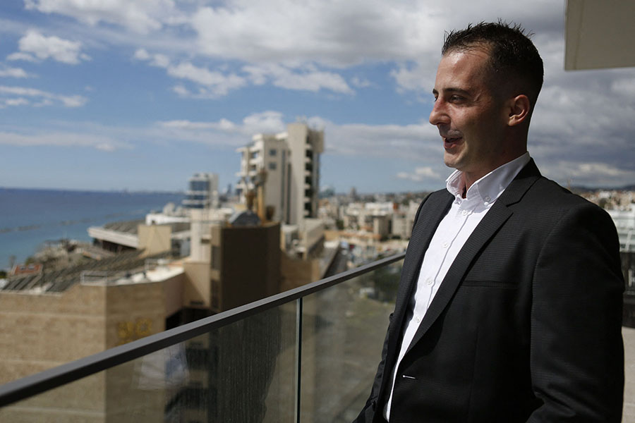 French real estate agent Florent Gastine standing on the balcony of an apartment in Limassol.
Image: Alex Mita / AFP 