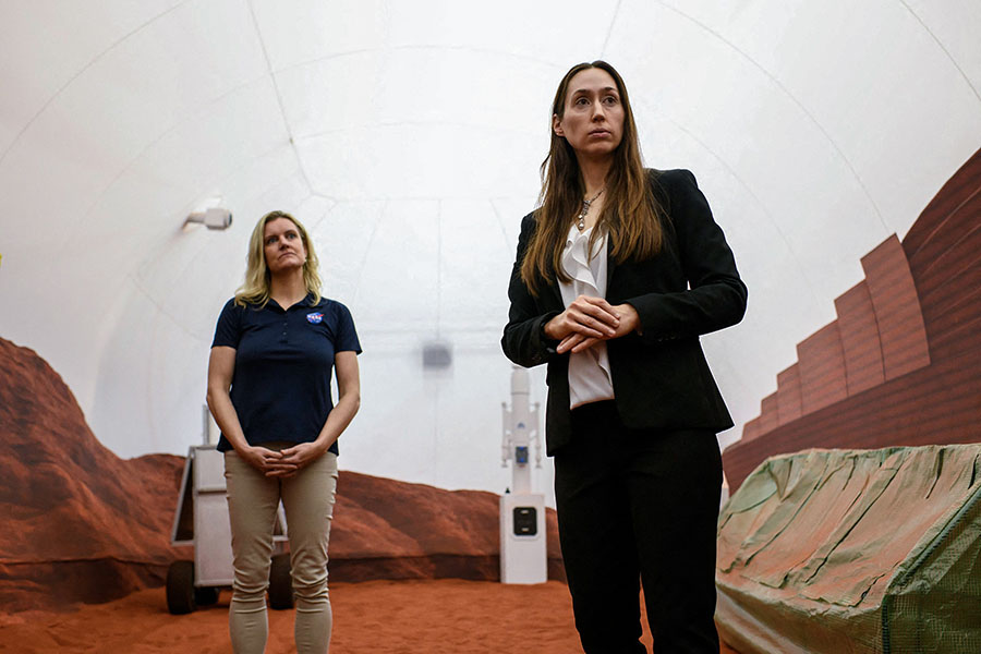 (L-R) Dr. Suzanne Bell, Lead for NASA’s Behavioral Health and Performance Laboratory, and Dr. Grace Douglas, CHAPEA principal investigator, answer questions from the media in a simulated Mars exterior portion of the CHAPEA’s Mars Dune Alpha.
Image: Mark Felix / AFP 