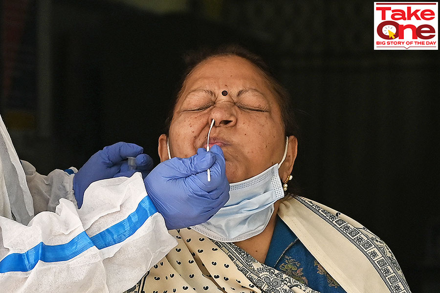 A healthcare worker collects a swab sample of a woman for Covid-19 test, amid a rise in coronavirus cases in India, in New Delhi on April 17, 2023. Image: Arrush Chopra/NurPhoto via Getty Images