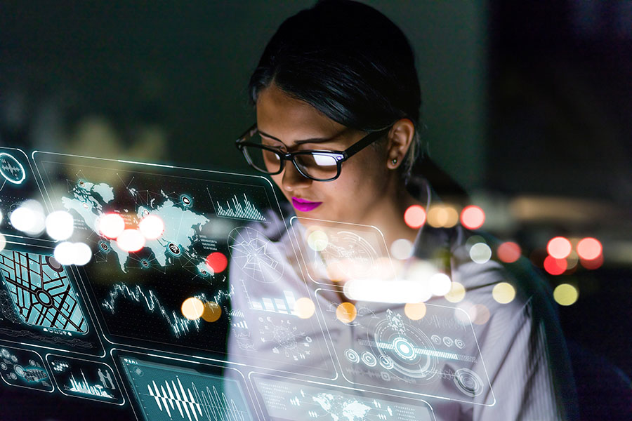  
A woman wearing glasses looks at code on a computer screen.
Image: Shutterstock