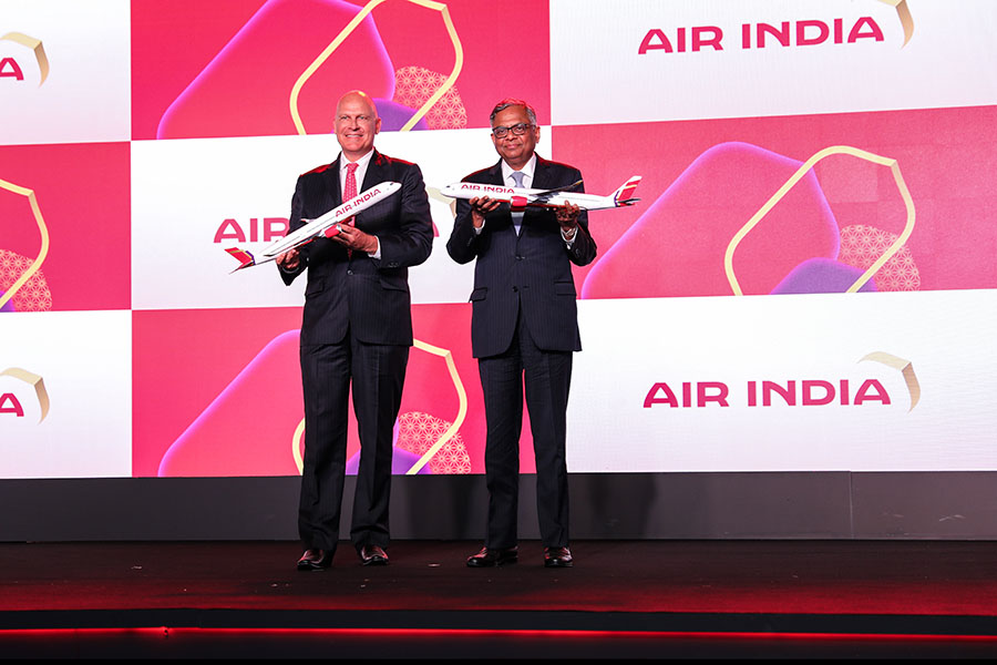 Campbell Wilson, CEO and MD, Air India, and N Chandrasekaran, chairman, Tata Group unveil the new livery of the airline at the brand relaunch event. Image: Air India 