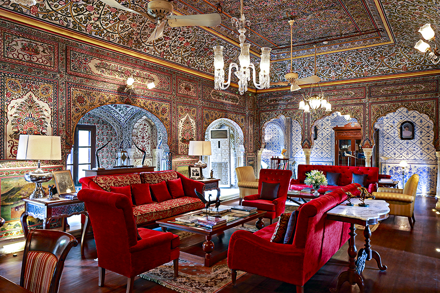 The magnificent living room of Samode Haveli, where the walls are adorned from floor to ceiling with hand-painted frescoes, dating back to the illustrious 18th century  