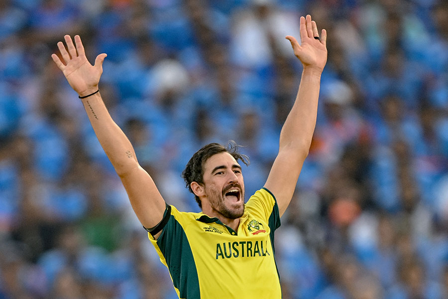 Australia's Mitchell Starc celebrates after taking the wicket of India's KL Rahul during the 2023 ICC Men's Cricket World Cup one-day international (ODI) final match between India and Australia at the Narendra Modi Stadium in Ahmedabad on November 19, 2023. Image: Sajjad Hussain / AFP