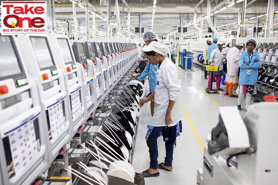 Employees work on an assembly line in the mobile phone plant of Rising Stars Mobile India Pvt., a unit of Foxconn Technology Co. in Sriperumbudur, Tamil Nadu. Image: Karen Dias/Bloomberg via Getty Images